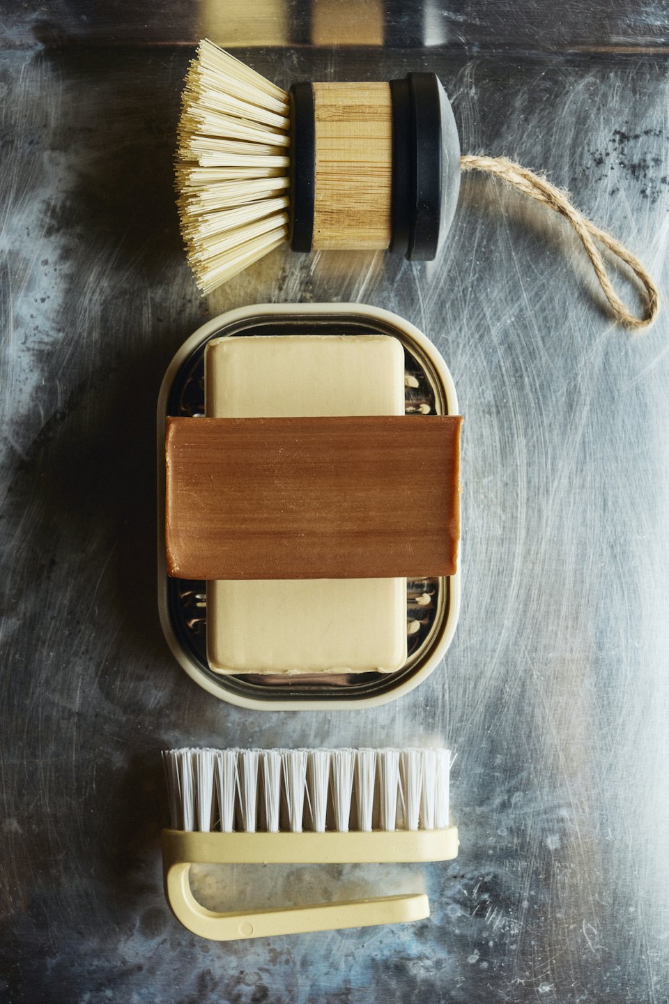 Sustainable cleaning products arranged neatly on a metal surface.